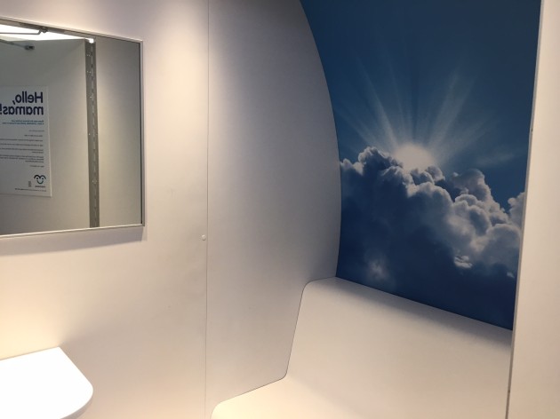 The interior of the mamava pod—all white except for cloud mural on one wall. Photo credit: Amy Stone. 