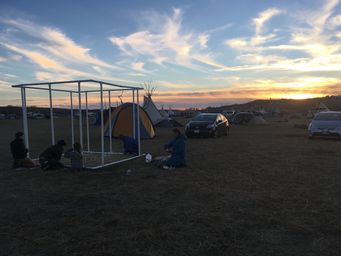 Building our sukkah at Oceti Sakowin with the help of our neighbors.