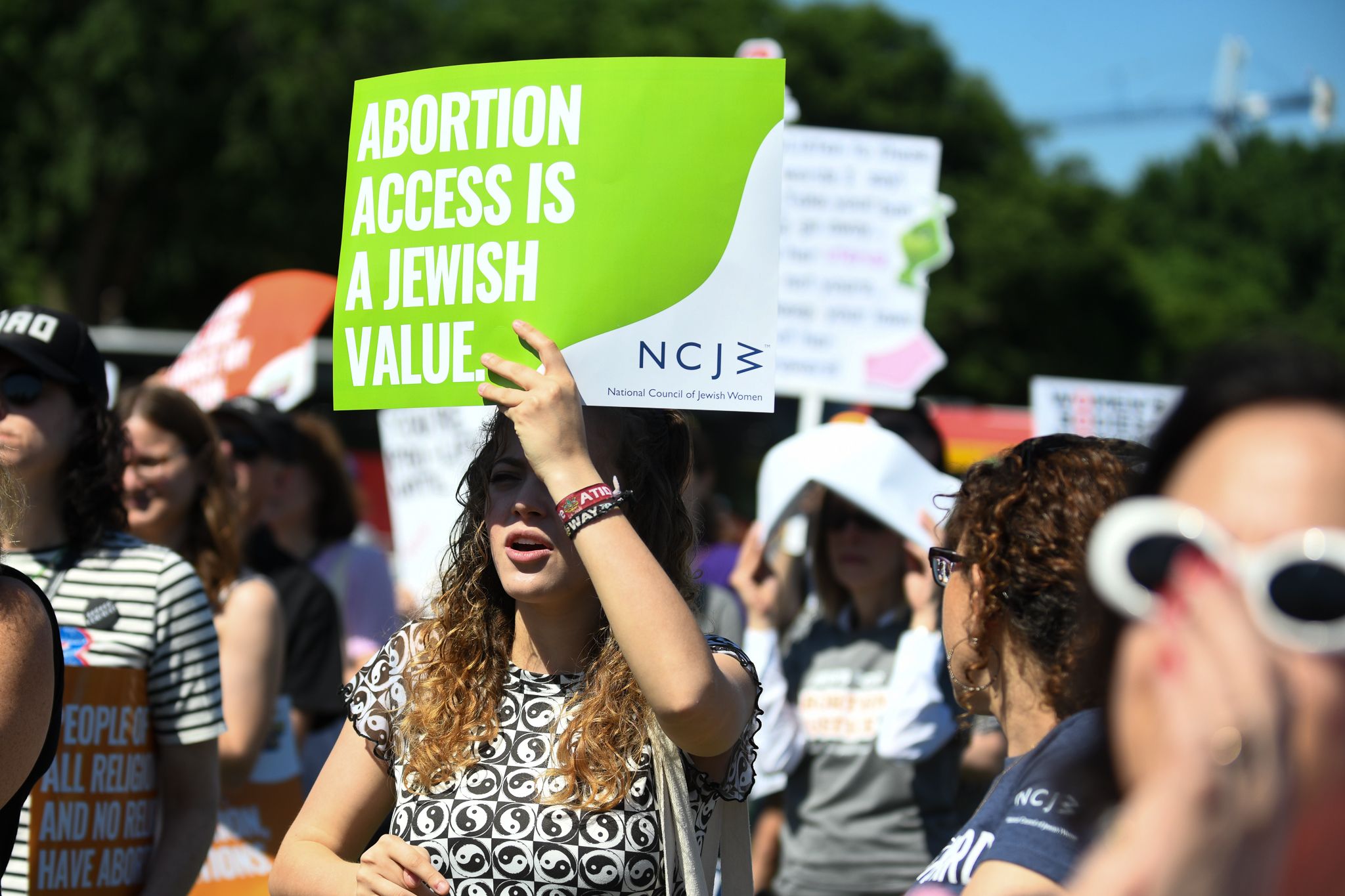 Rallygoers hold up a sign saying "abortion access is a Jewish value."